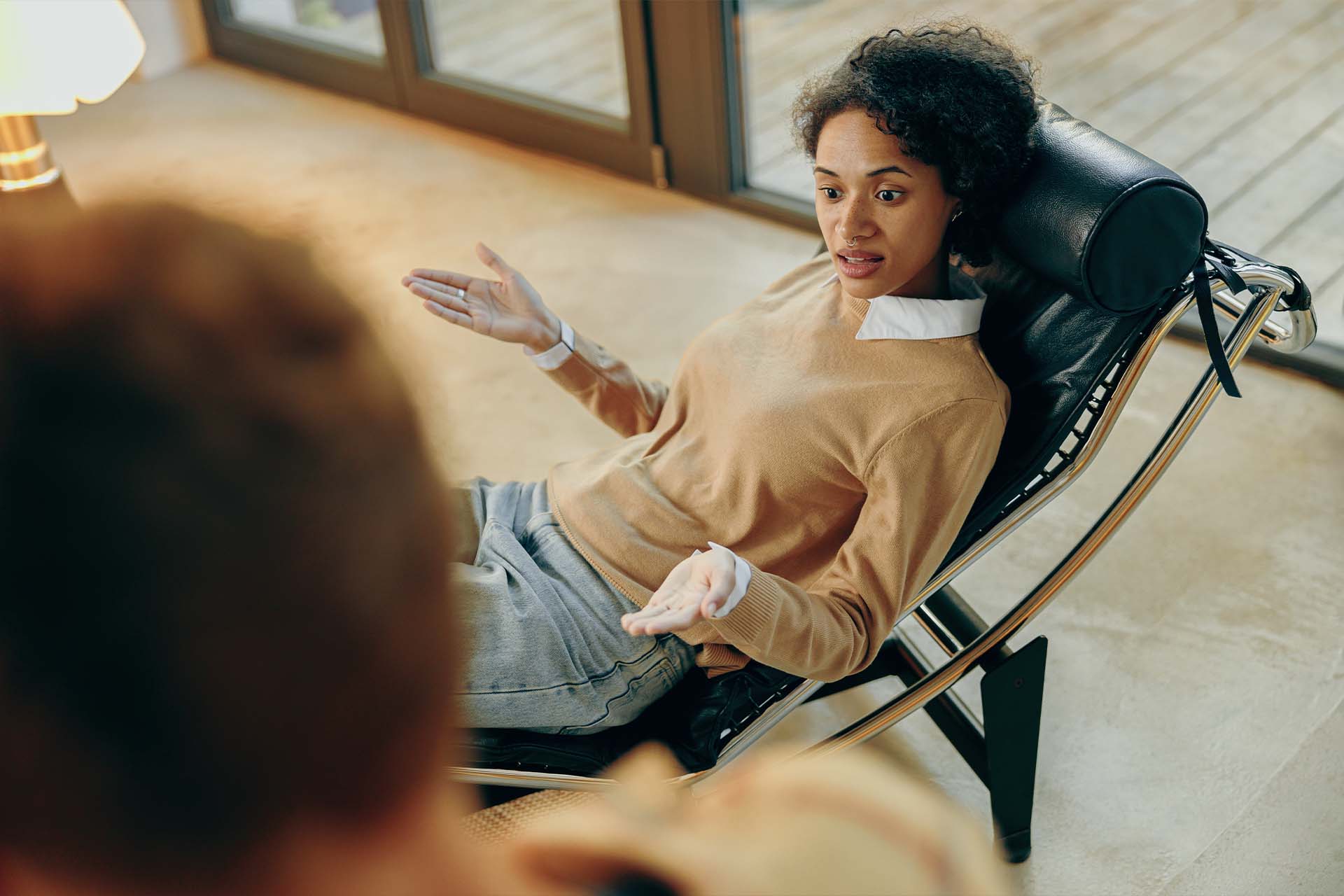 An individual engaging in a counseling session, focusing on present relationships and personal accountability, emblematic of reality therapy