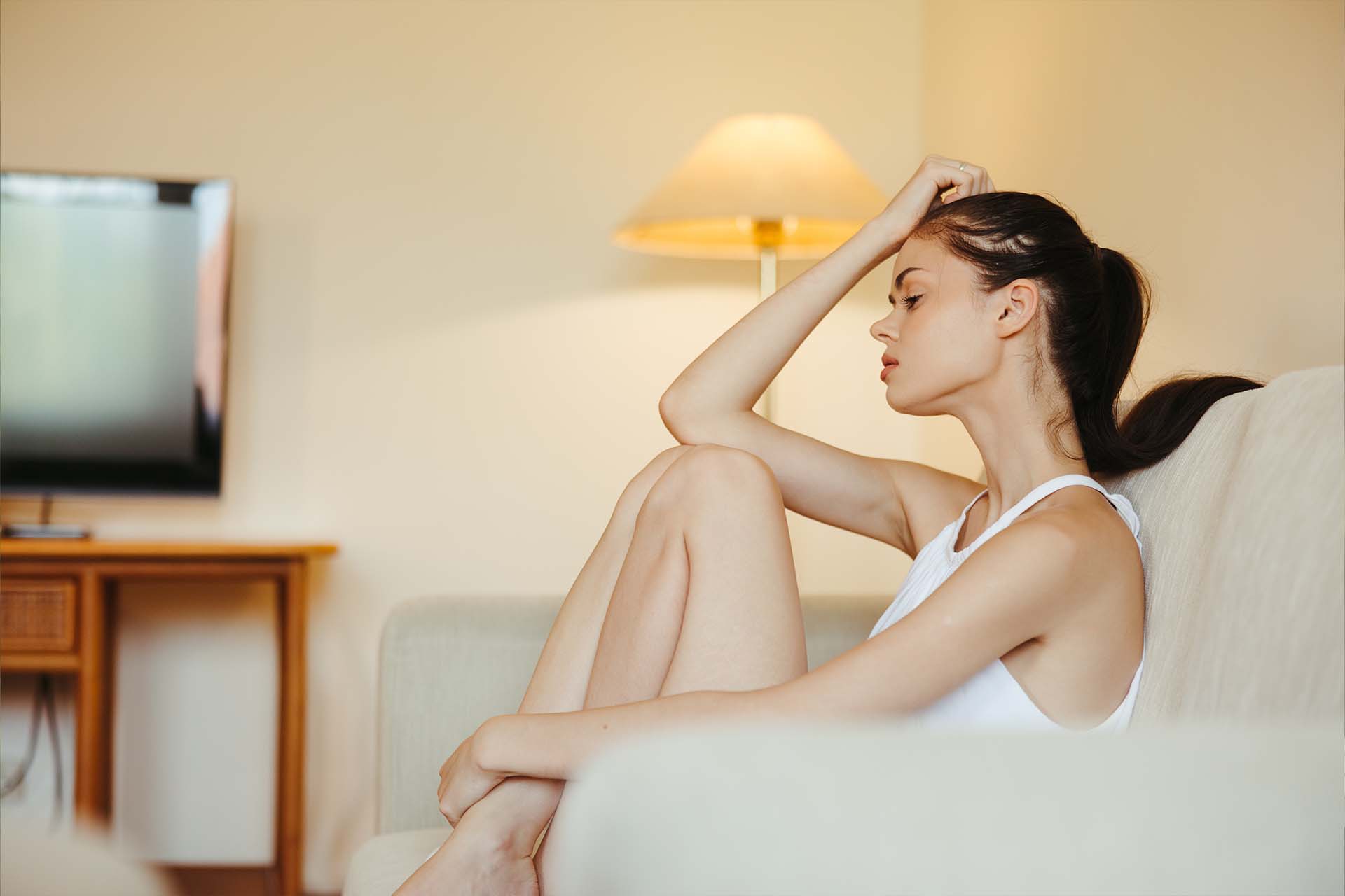 A person sitting thoughtfully by a window, symbolizing the emotional weight of Adjustment Disorder with Depressed Mood.