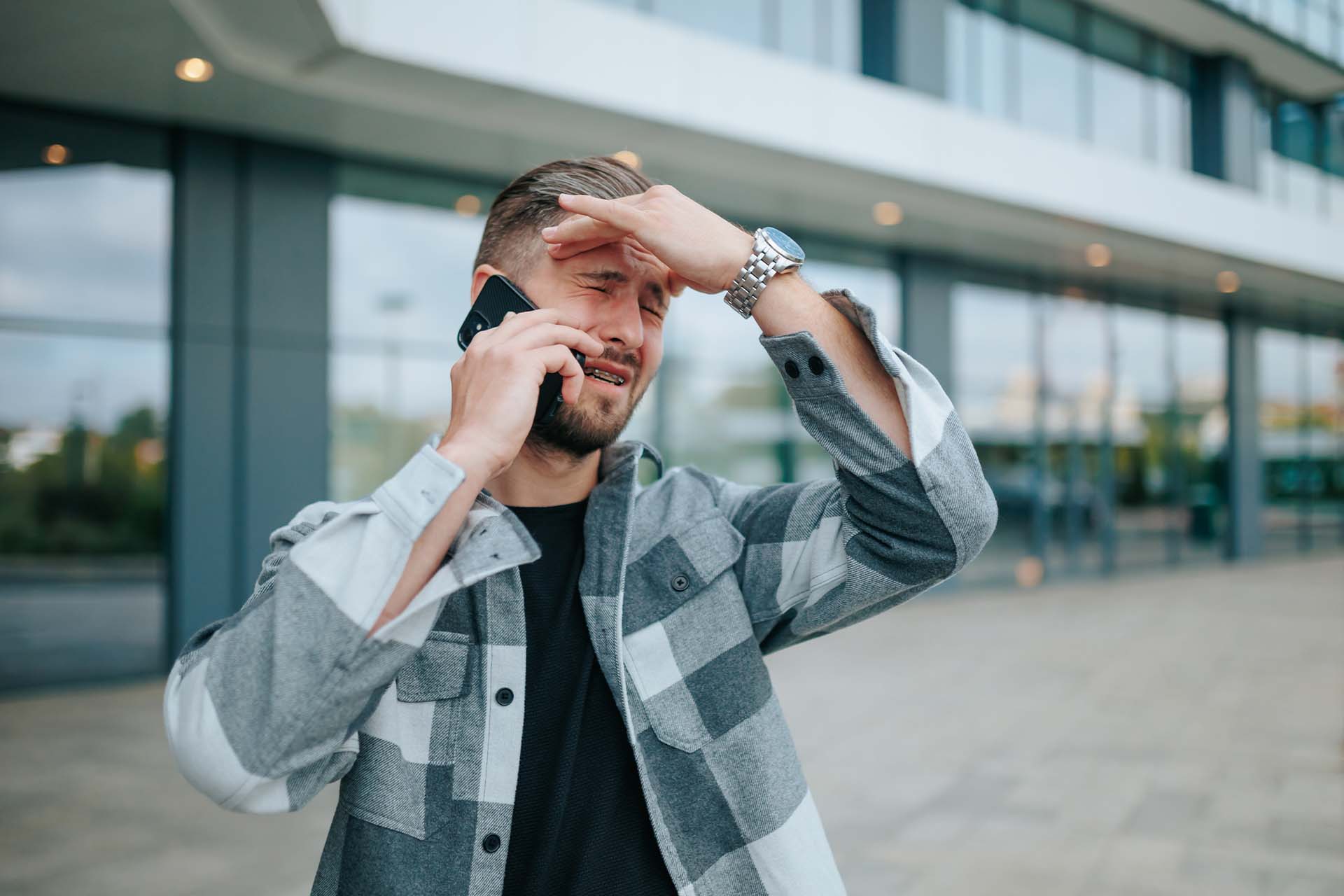 A person holding their head in distress, symbolizing the anxiety triggered by substance use.