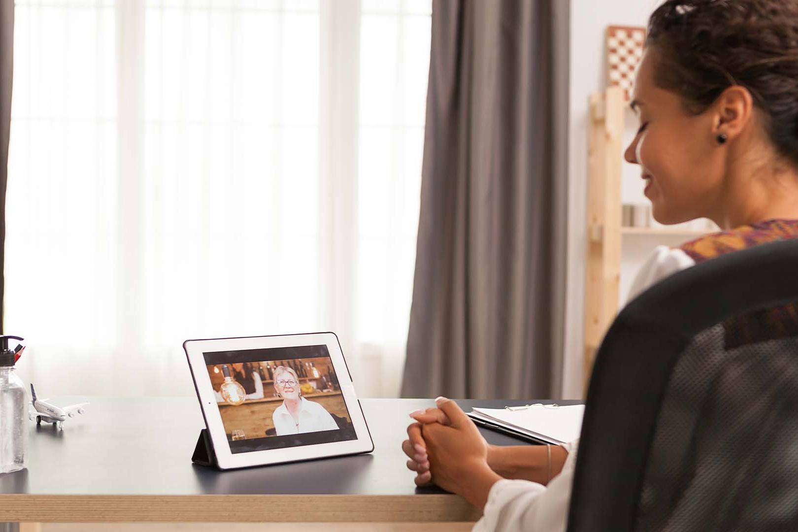 A virtual therapy session illustrating non-invasive Transcranial Magnetic Stimulation (TMS) techniques used to support mental health treatment through teletherapy.