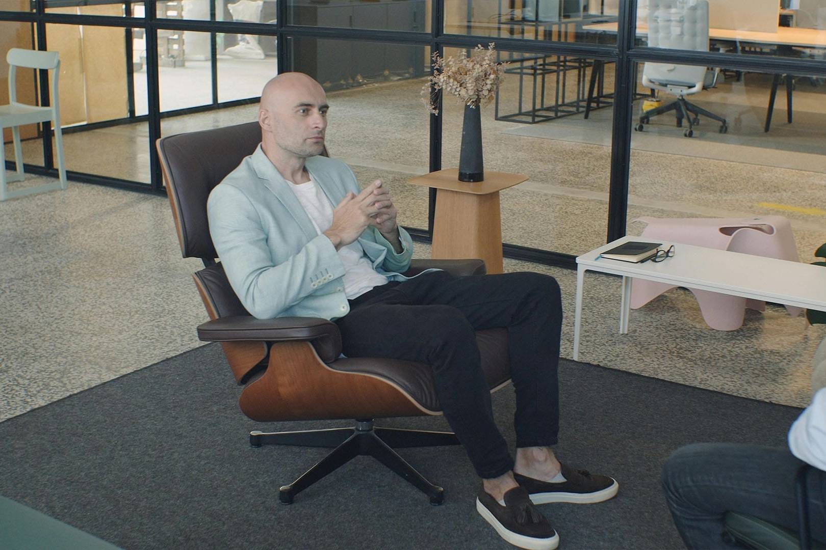 A therapist listens attentively during a one-on-one session focused on helping a client through mid-life transitions in a modern office.