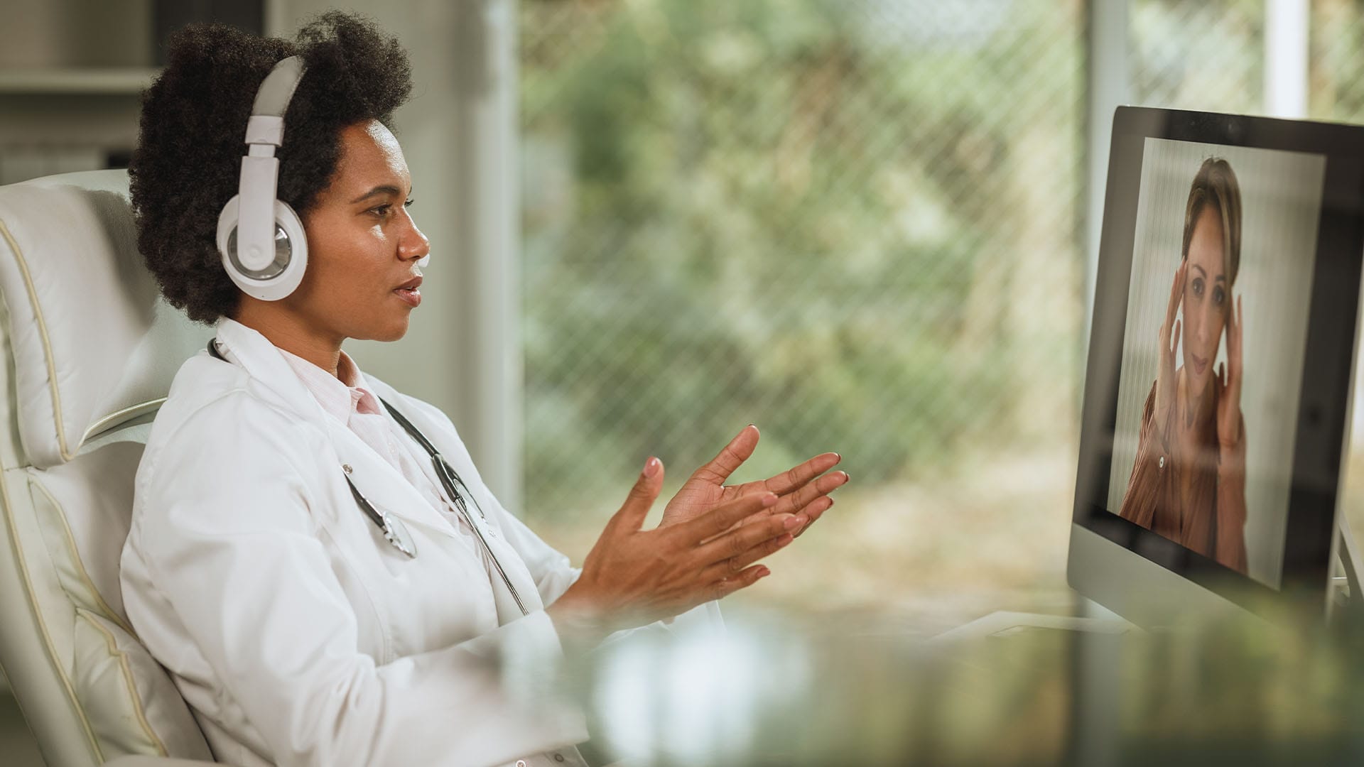 Doctor listening attentively to a distressed patient during an online therapy session about setting personal boundaries.