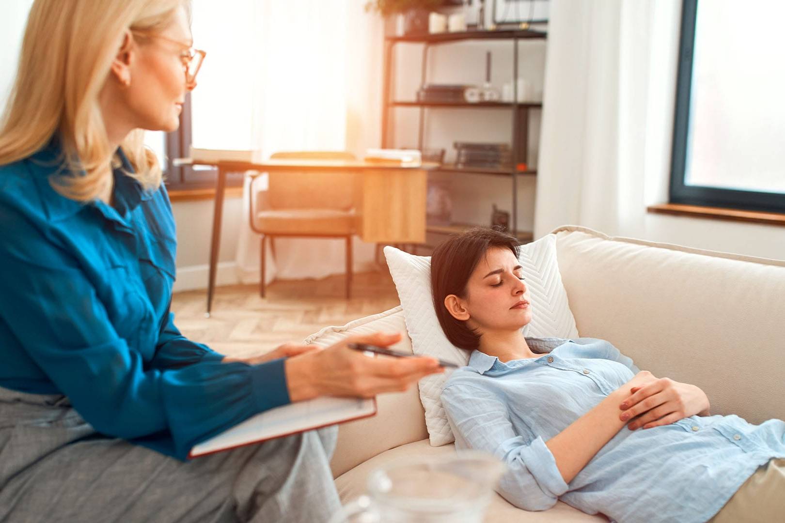 Therapist providing a private, high-end counseling session for a client in a calm setting.