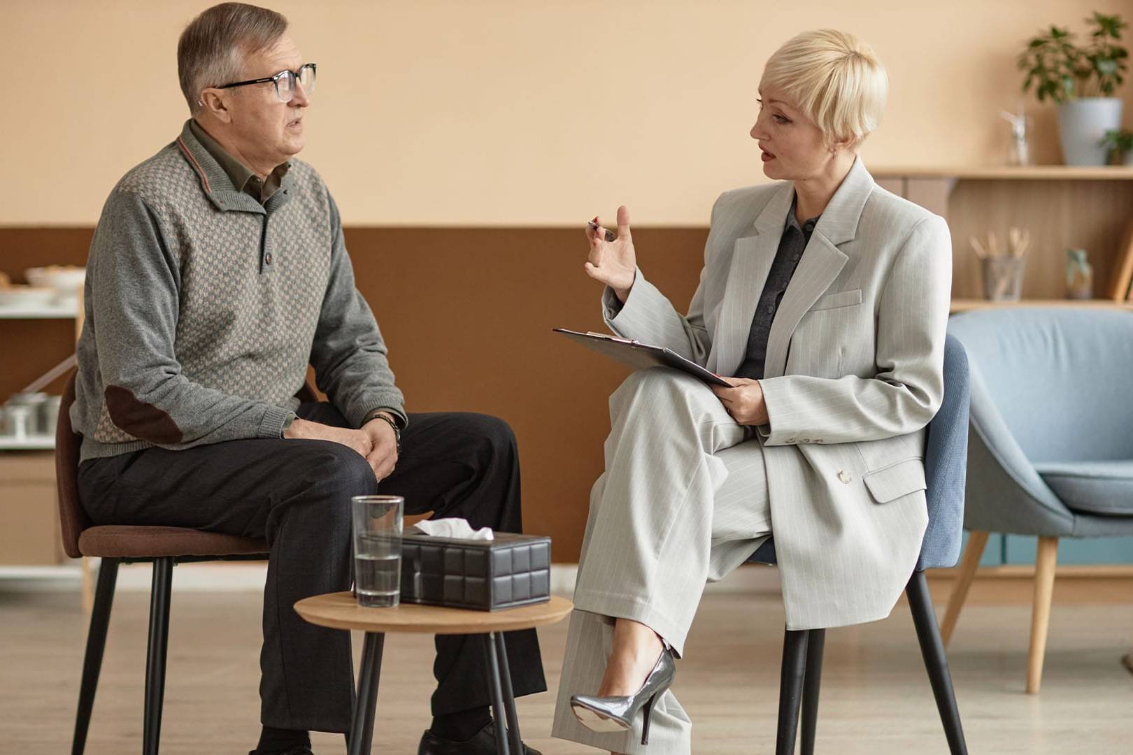 Therapist discussing Internal Family Systems (IFS) therapy with a client during a calm, focused session.