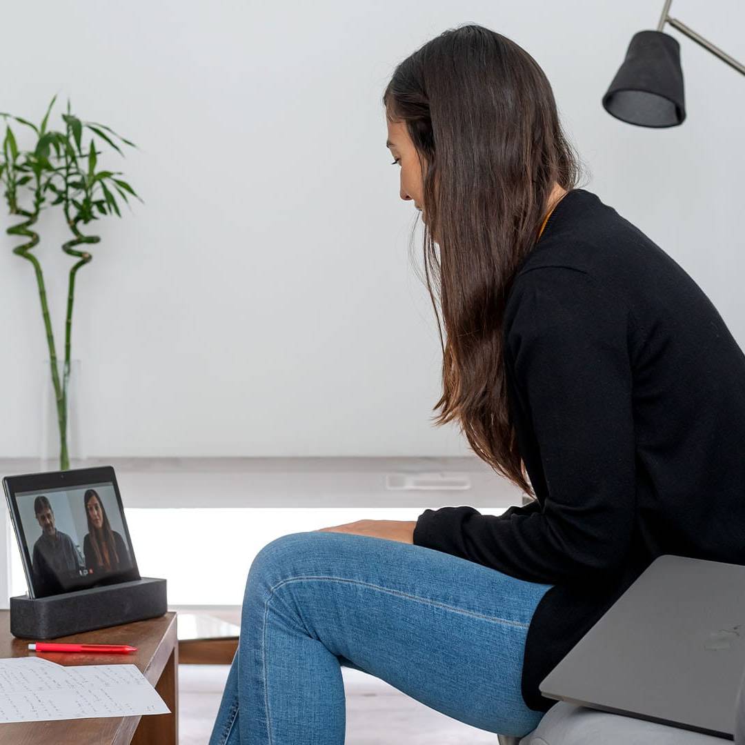 Woman attending an online therapy session on a tablet, representing private pay care