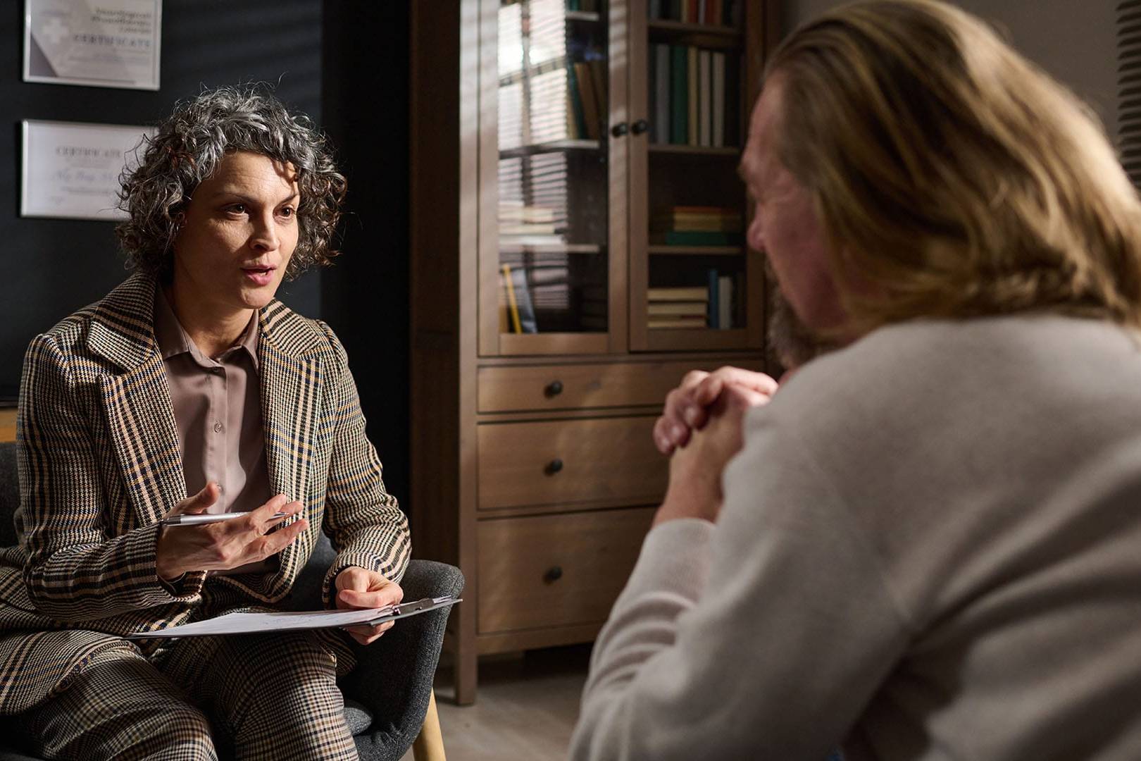 Therapist speaking with a client in a private office, representing luxury therapy services in Beverly Hills with discreet counseling for high-profile clients.