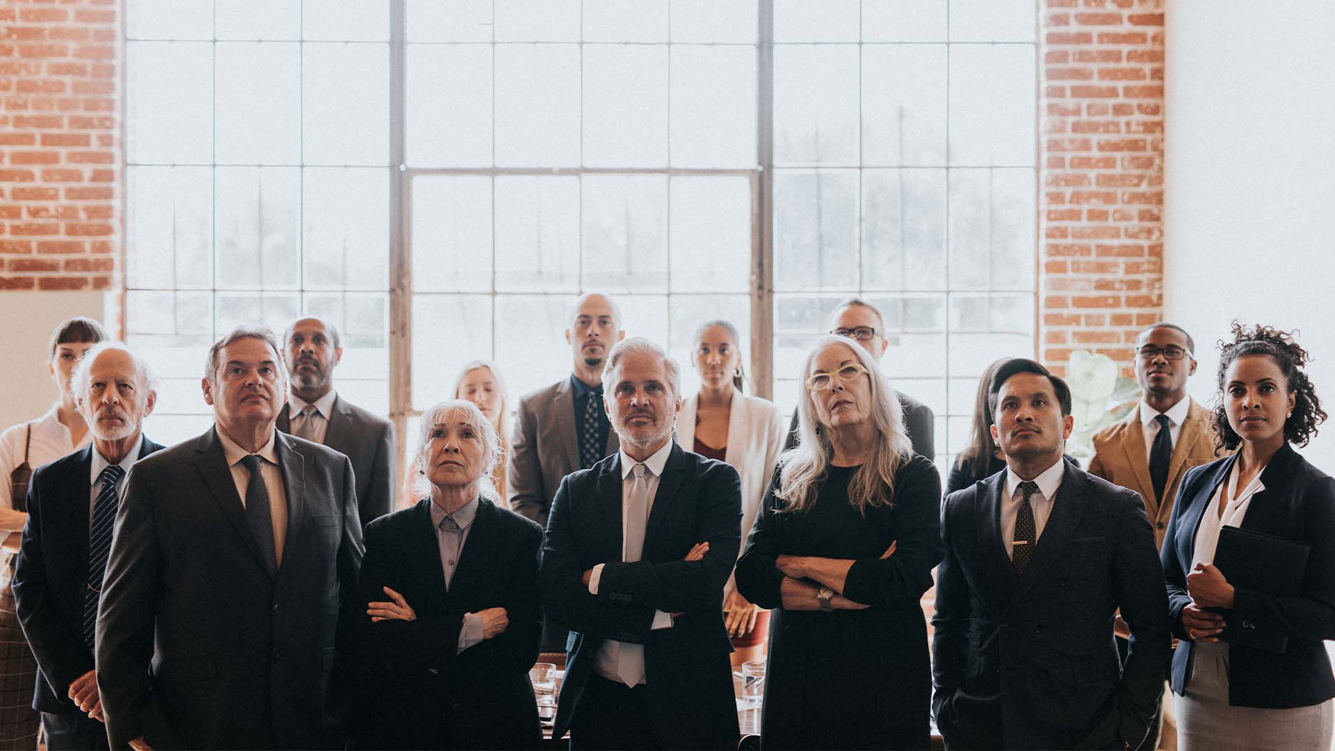 Therapy for attorneys in California — group of serious professionals in suits symbolizing high-stakes legal careers and workplace stress.