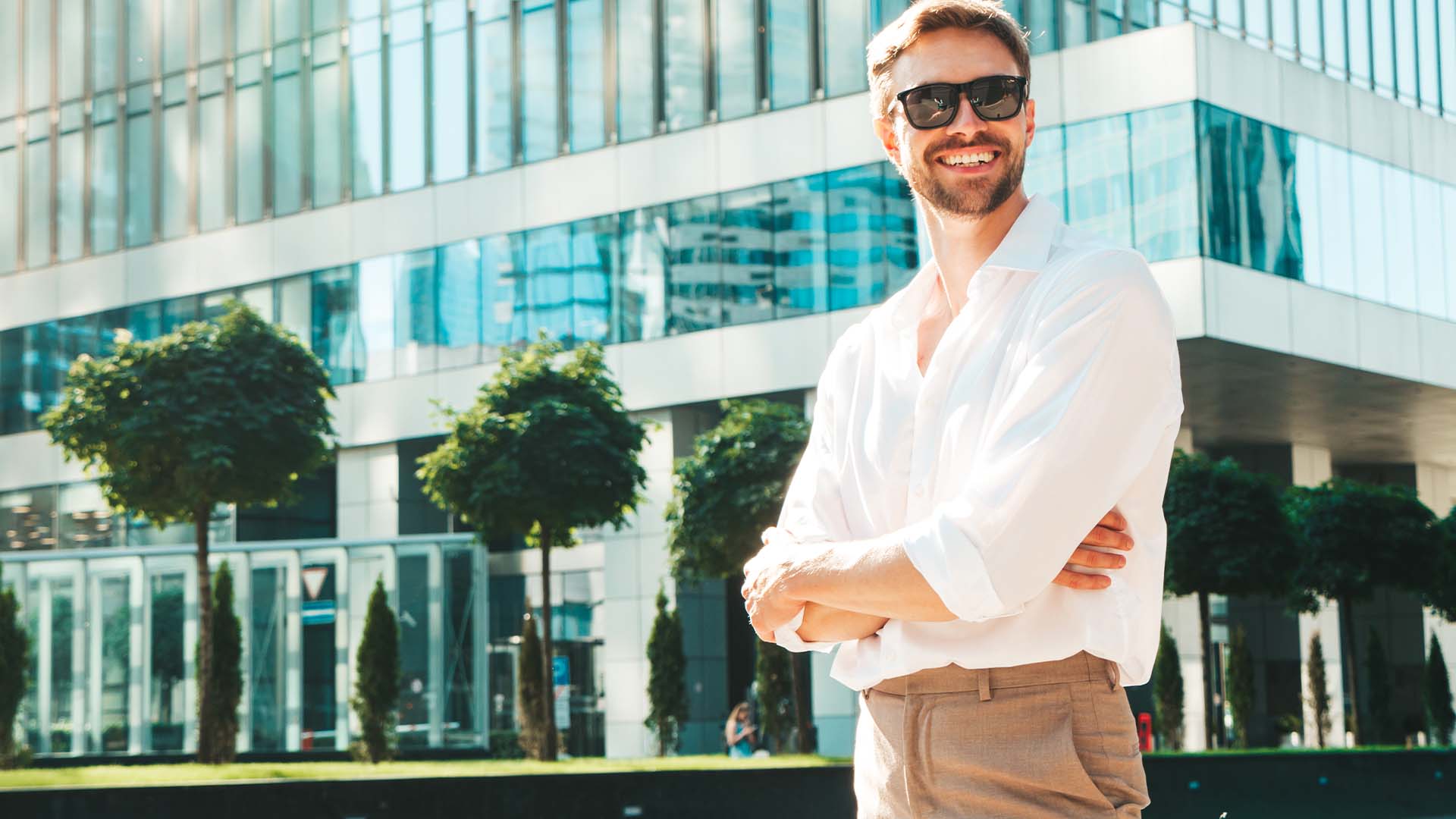 Confident California CEO standing outside modern corporate headquarters, representing chief executives managing organizational leadership in competitive state business environment