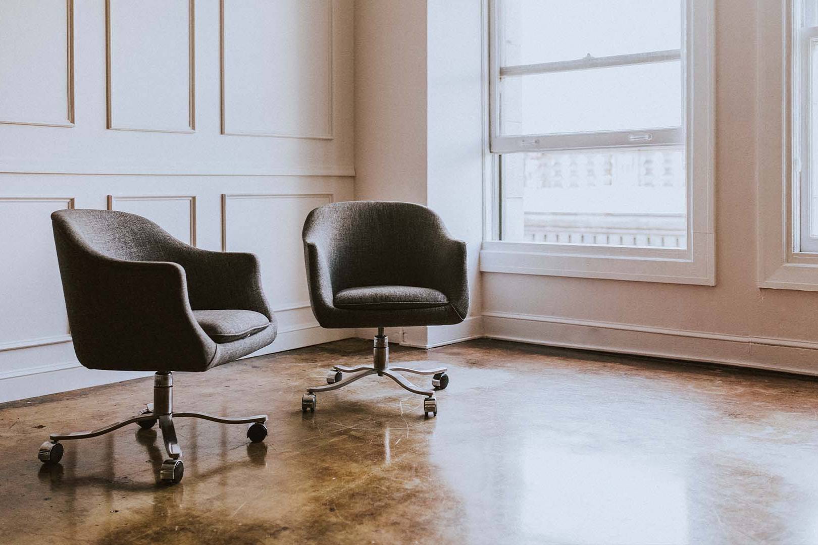 Modern minimalist therapy office with two chairs representing contemporary mental health treatment modalities and therapeutic approaches