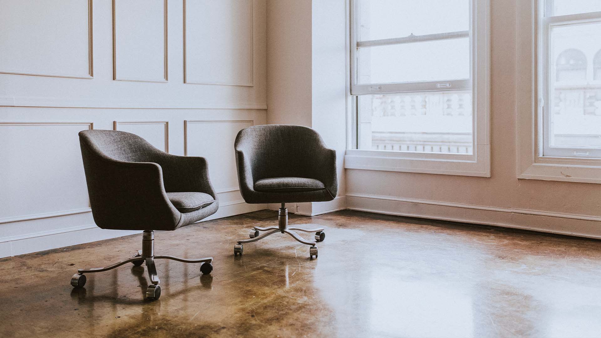 Modern minimalist therapy office with two chairs representing contemporary mental health treatment modalities and therapeutic approaches