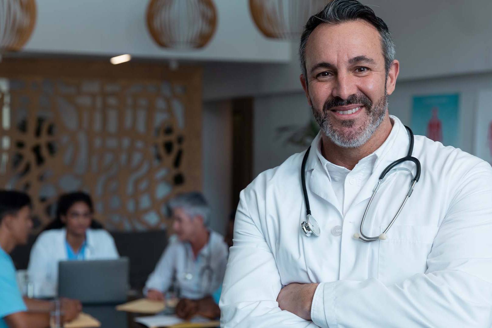 California physician with stethoscope and medical team background representing doctors experiencing burnout needing specialized confidential therapy