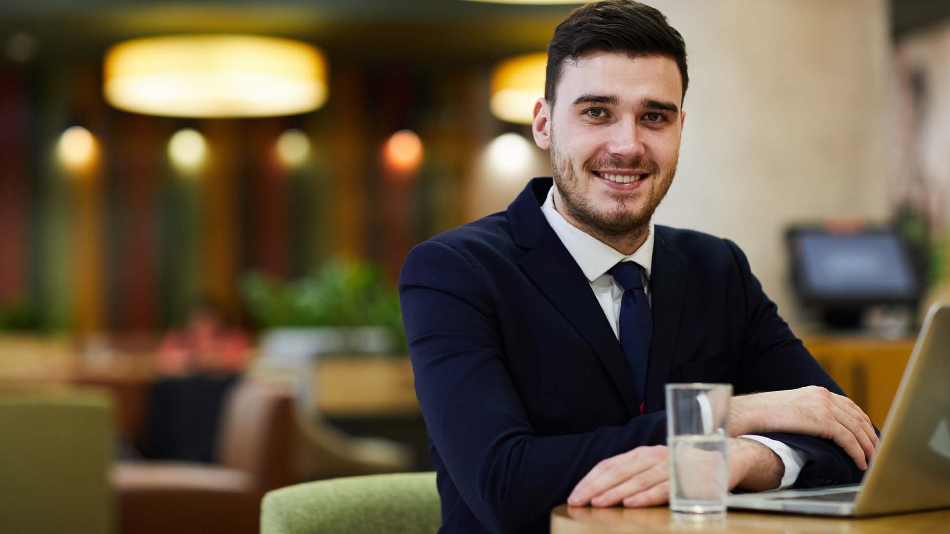 Confident licensed professional in business suit at modern office space, representing credentialed professionals seeking confidential therapy without board reporting