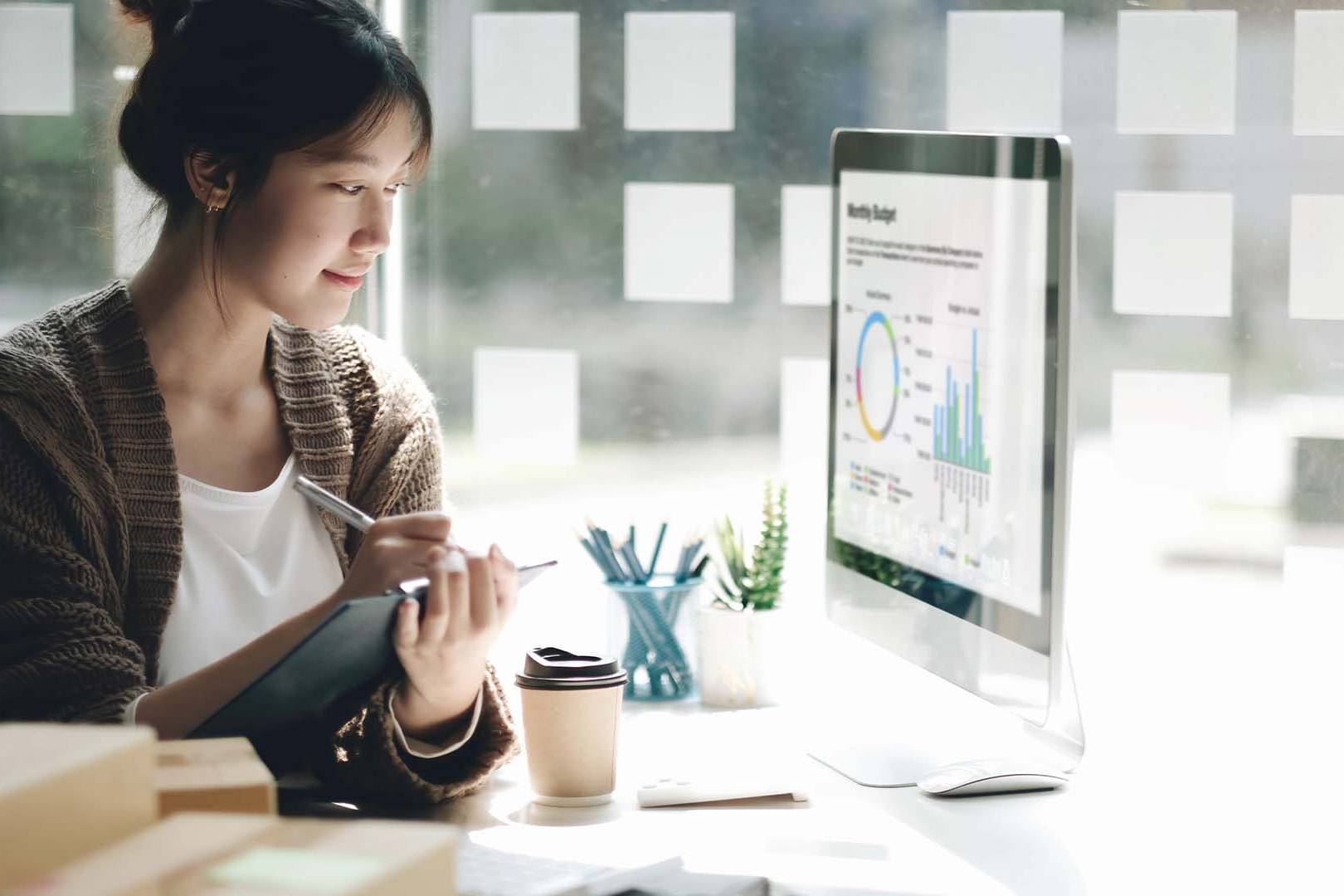 FinTech founder reviewing financial analytics and market data on screen in San Francisco office, representing the constant pressure of financial technology entrepreneurship