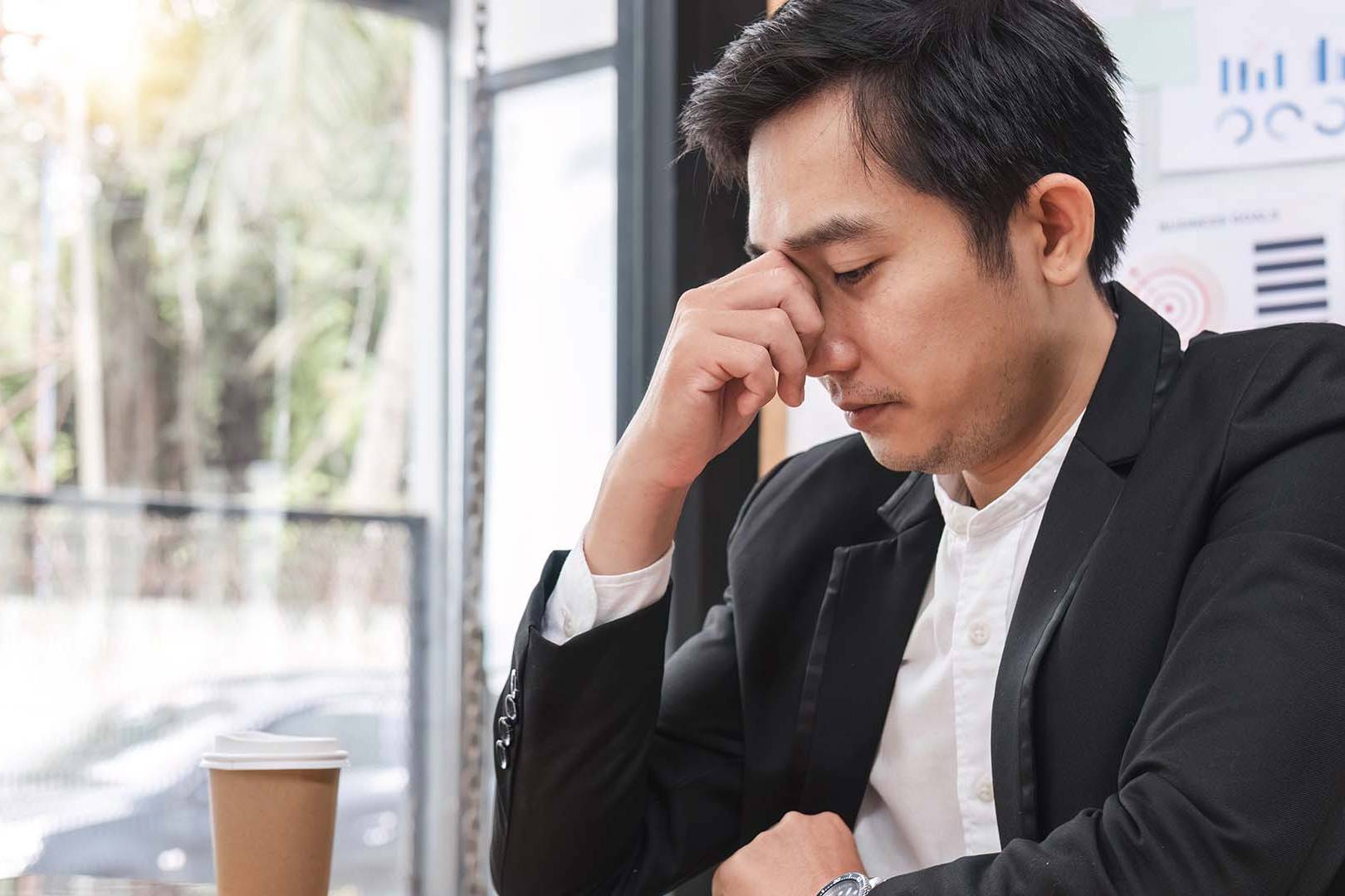 California executive experiencing leadership isolation and stress alone in office setting