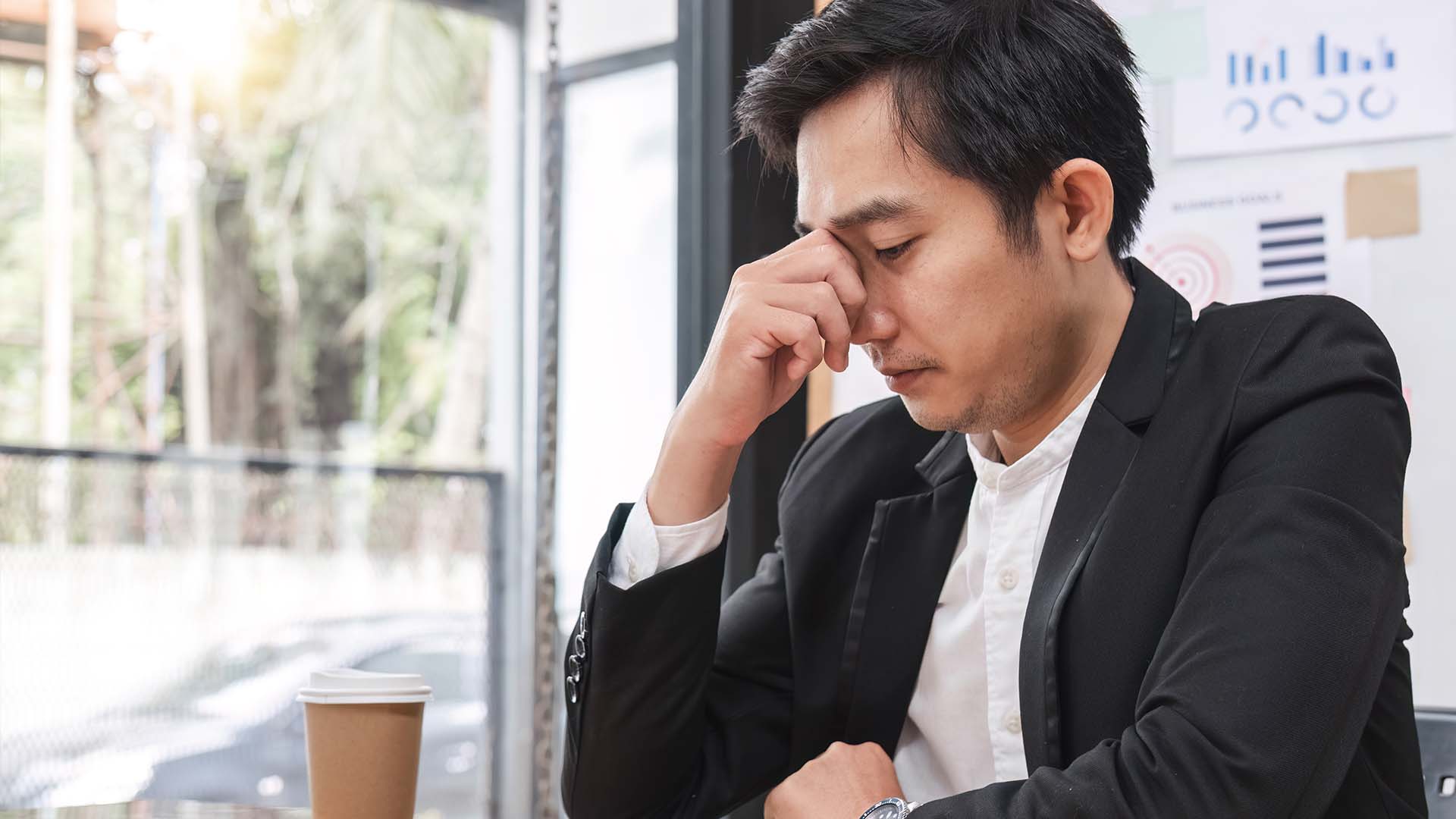 California executive experiencing leadership isolation and stress alone in office setting