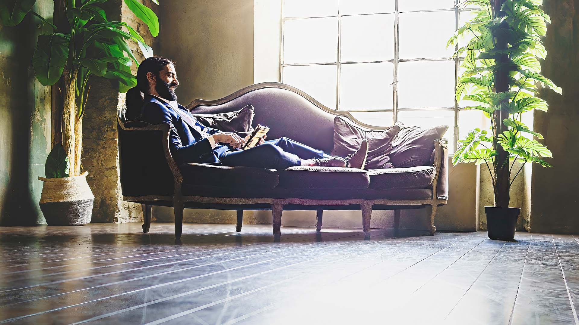 New law firm partner in business suit reclining thoughtfully in elegant office space, representing the complex transition and pressures of partnership