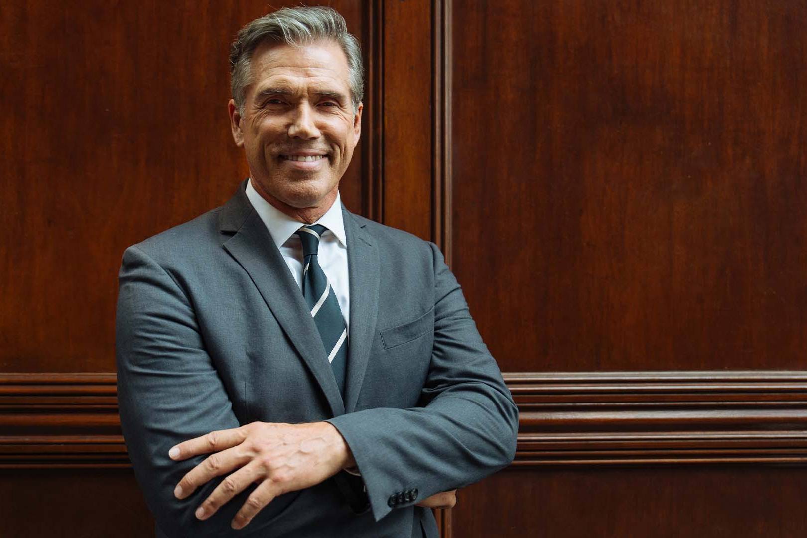 Confident mature male attorney in a suit representing ABA research on the lawyer mental health crisis.