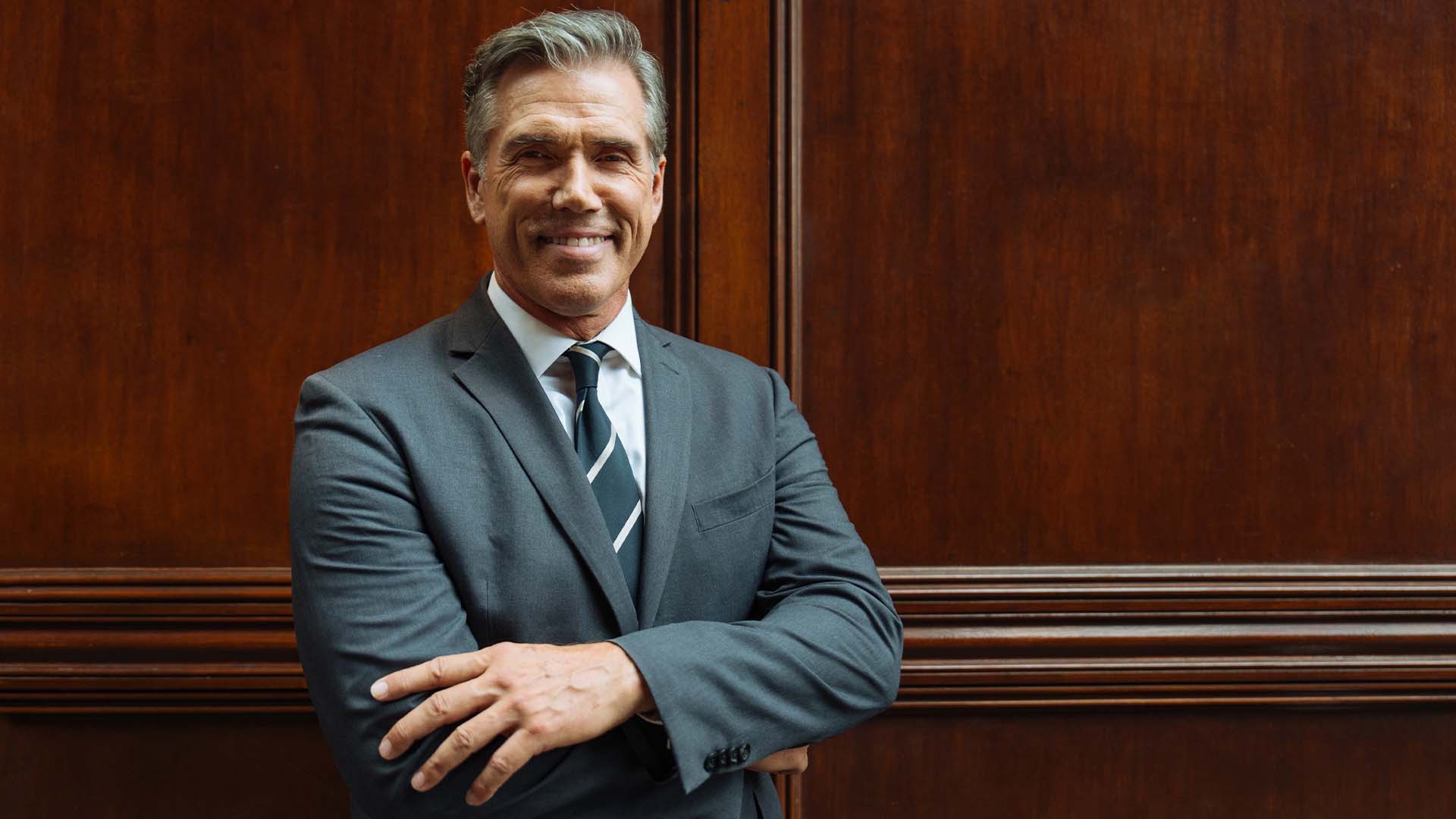 Confident mature male attorney in a suit representing ABA research on the lawyer mental health crisis.