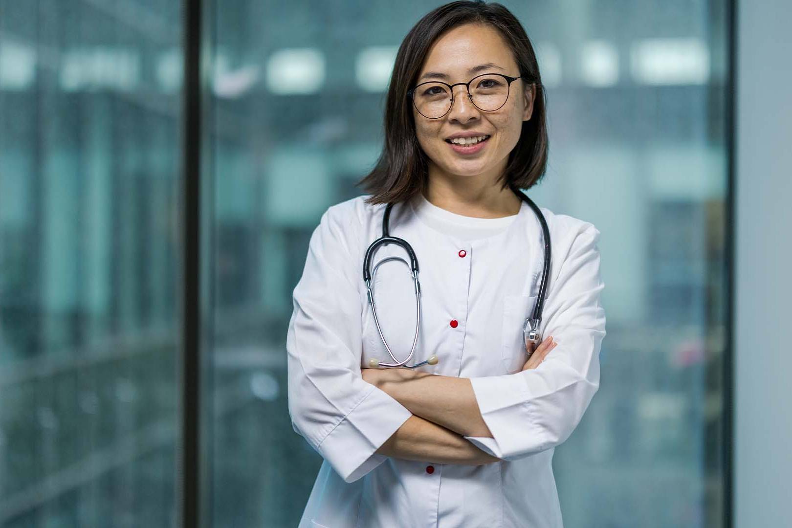 Confident female physician in lab coat with stethoscope
