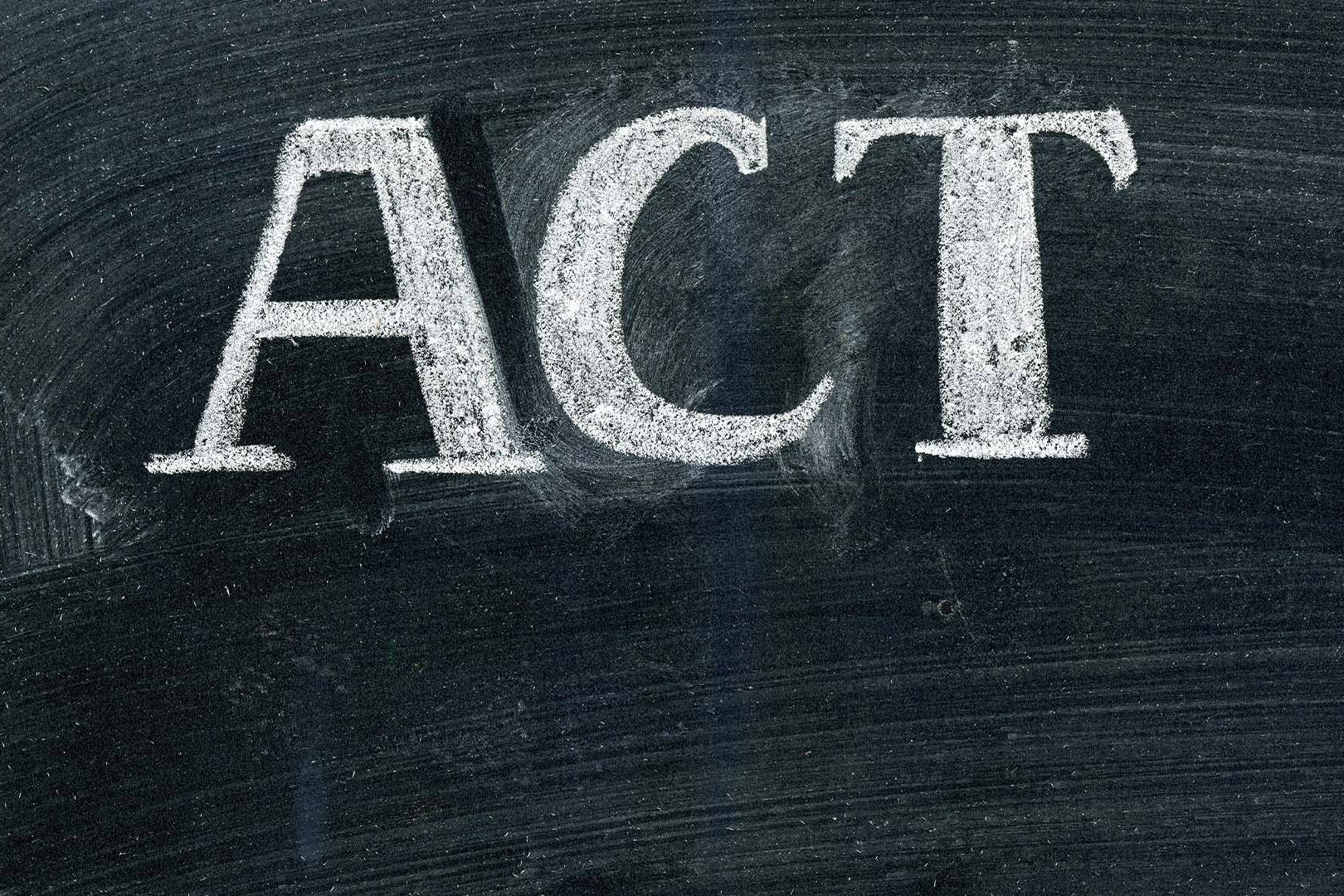 The acronym ACT written in bold white chalk on a dark chalkboard.