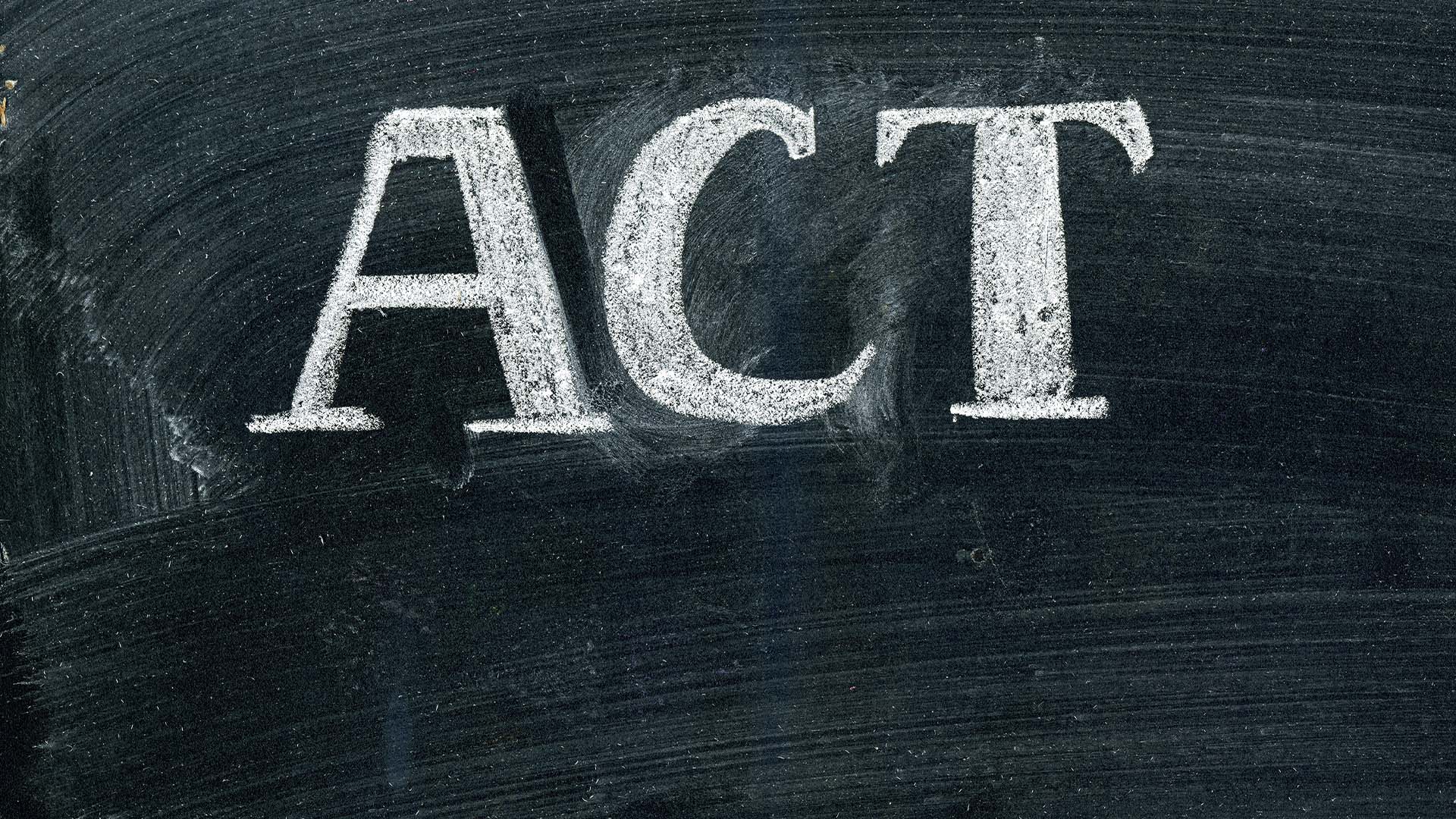 The acronym ACT written in bold white chalk on a dark chalkboard.