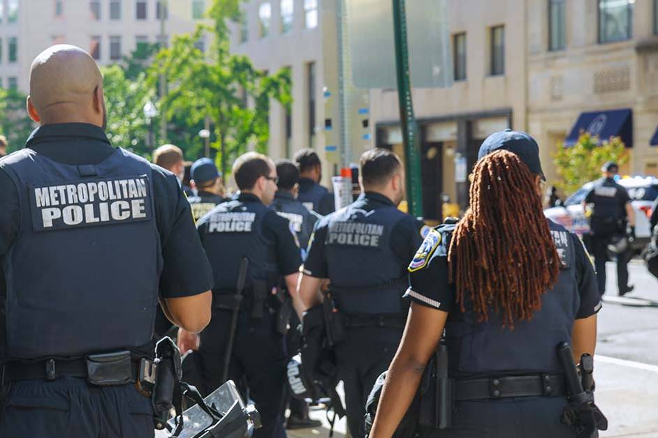A group of law enforcement officers in tactical vests walking together down a city street, featured image for the article Therapy for HSI, ICE, and CBP Officers.