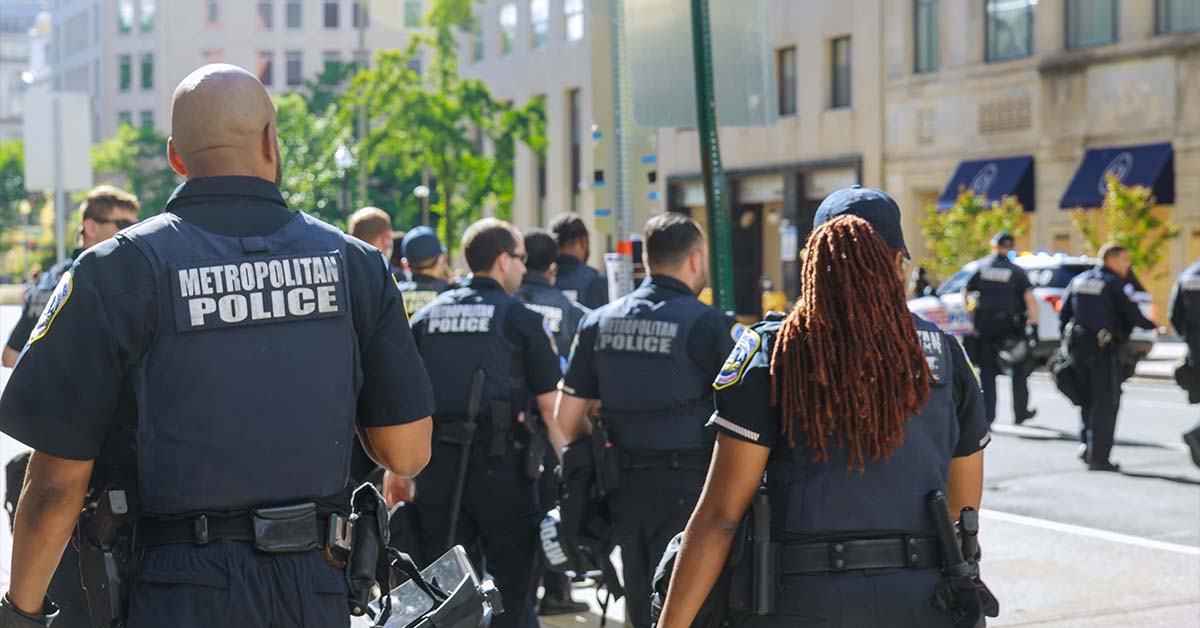 A group of law enforcement officers in tactical vests walking together down a city street, featured image for the article Therapy for HSI, ICE, and CBP Officers.
