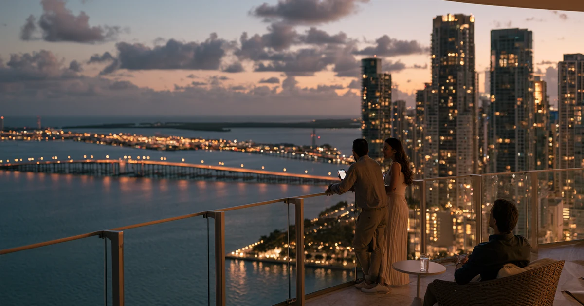 Couple a few feet apart on a Miami high-rise terrace over Biscayne Bay at dusk, illustrating couples therapy Miami with CEREVITY