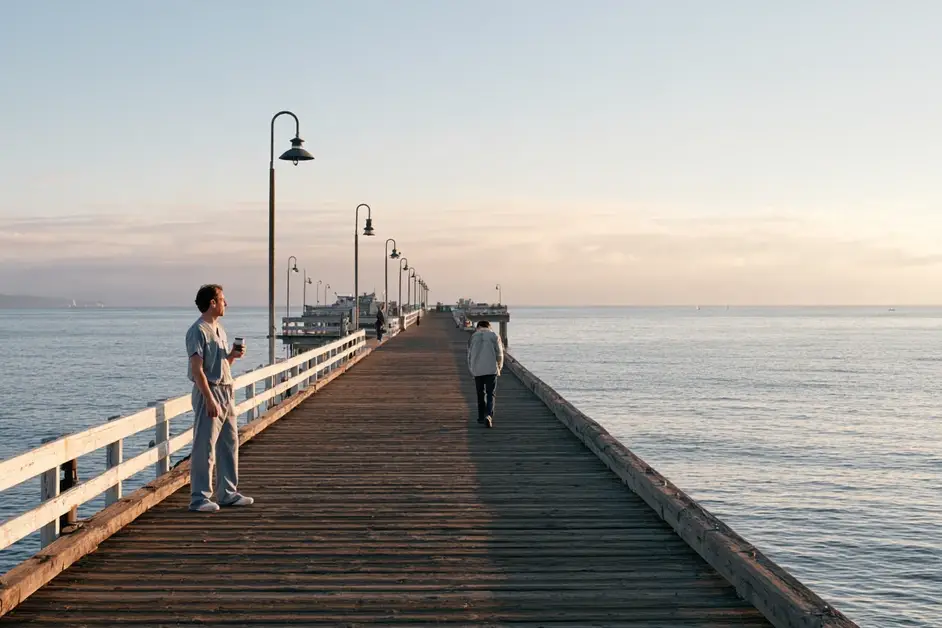 Couple a few feet apart at the end of a San Diego pier at dawn, illustrating couples therapy San Diego with CEREVITY